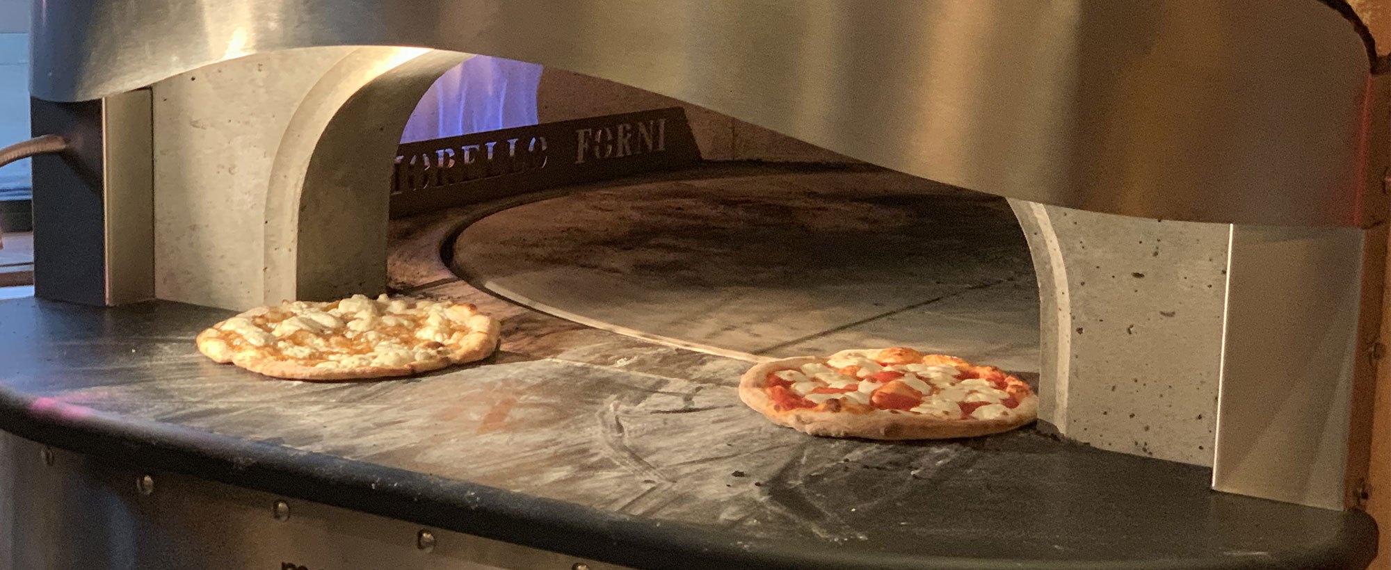 Watch your pizza cook in our stone fire oven